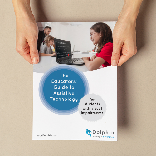 Hands holding a print-out of the Educators' Guide to Assistive Technology